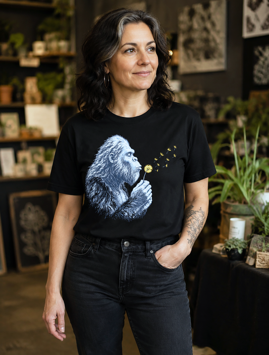Gorilla dandelion shirt model female botanical shop setting black and white gorilla blowing dandelion seeds graphic black tee wildlife art design