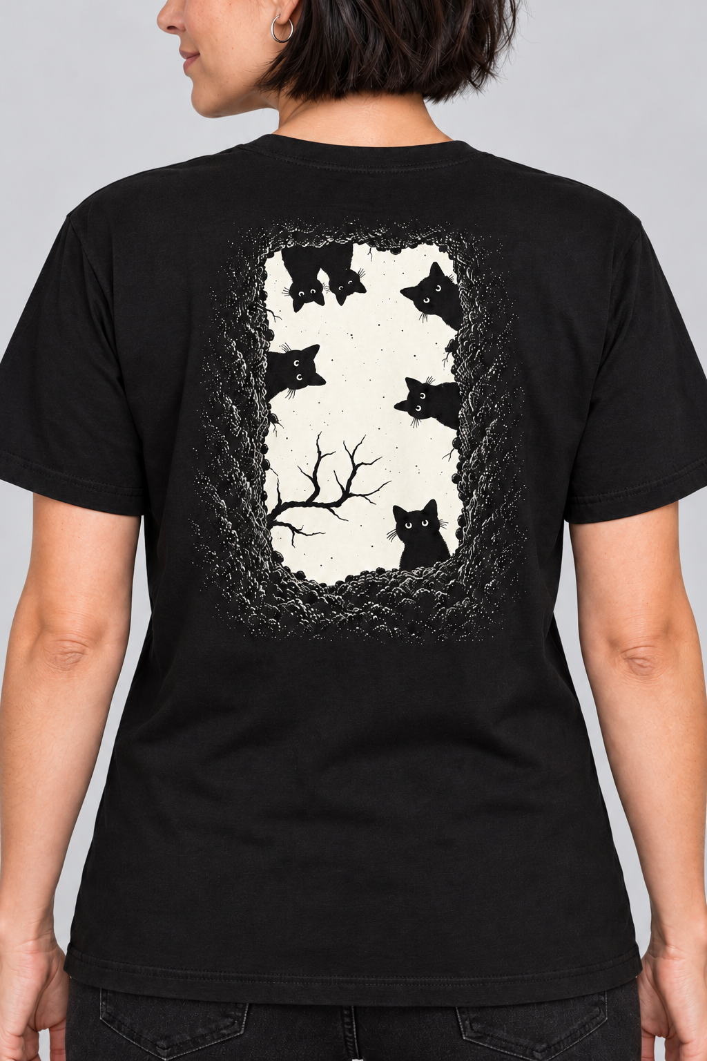 Close up view of back of grave danger t-shirt, black graphic tee, black cat grave illustration back, gothic wordmark front design, two-sided halloween shirt, spooky cemetery graphic print, cream ink gothic lettering, torn earth night sky design, eerie cat peeking art, unisex crew neck shirt