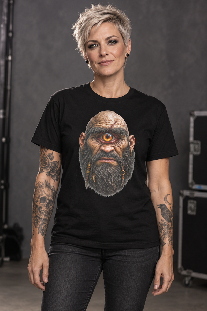 A woman wearing a cyclops t-shirt, black and white graphic tee, one eyed giant illustration, braided beard design, gold hoop earring graphic, scarred bald head design, mythical monster tee, halloween horror shirt, gothic streetwear design, unisex crew neck shirt