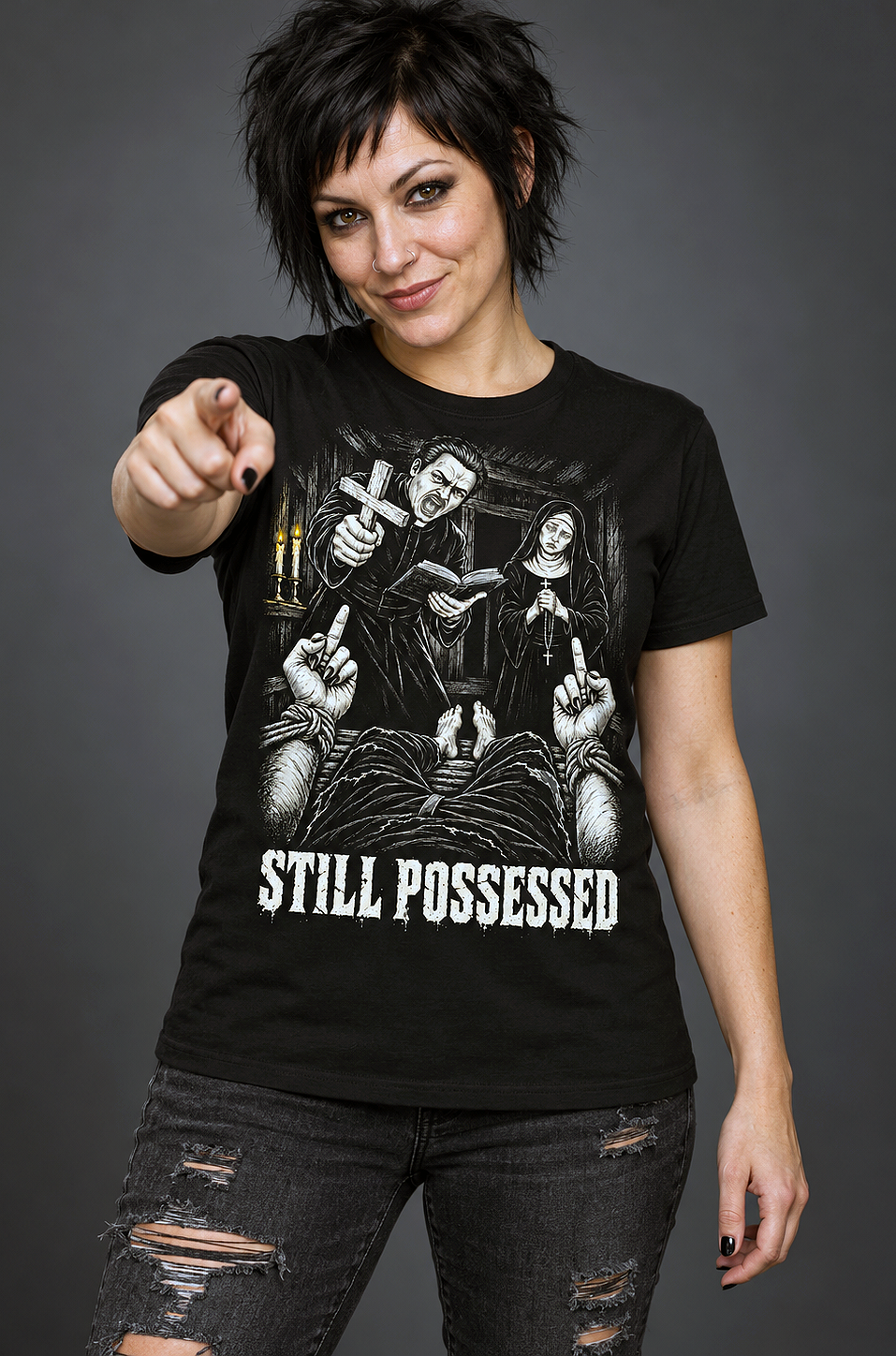A woman wearing a still possessed t-shirt, black graphic tee, gothic exorcism illustration, priest and nun horror design, bound demon hands graphic, defiant gesture horror print, candlelit dark scene art, distressed horror typography, black and white horror illustration, unisex crew neck shirt