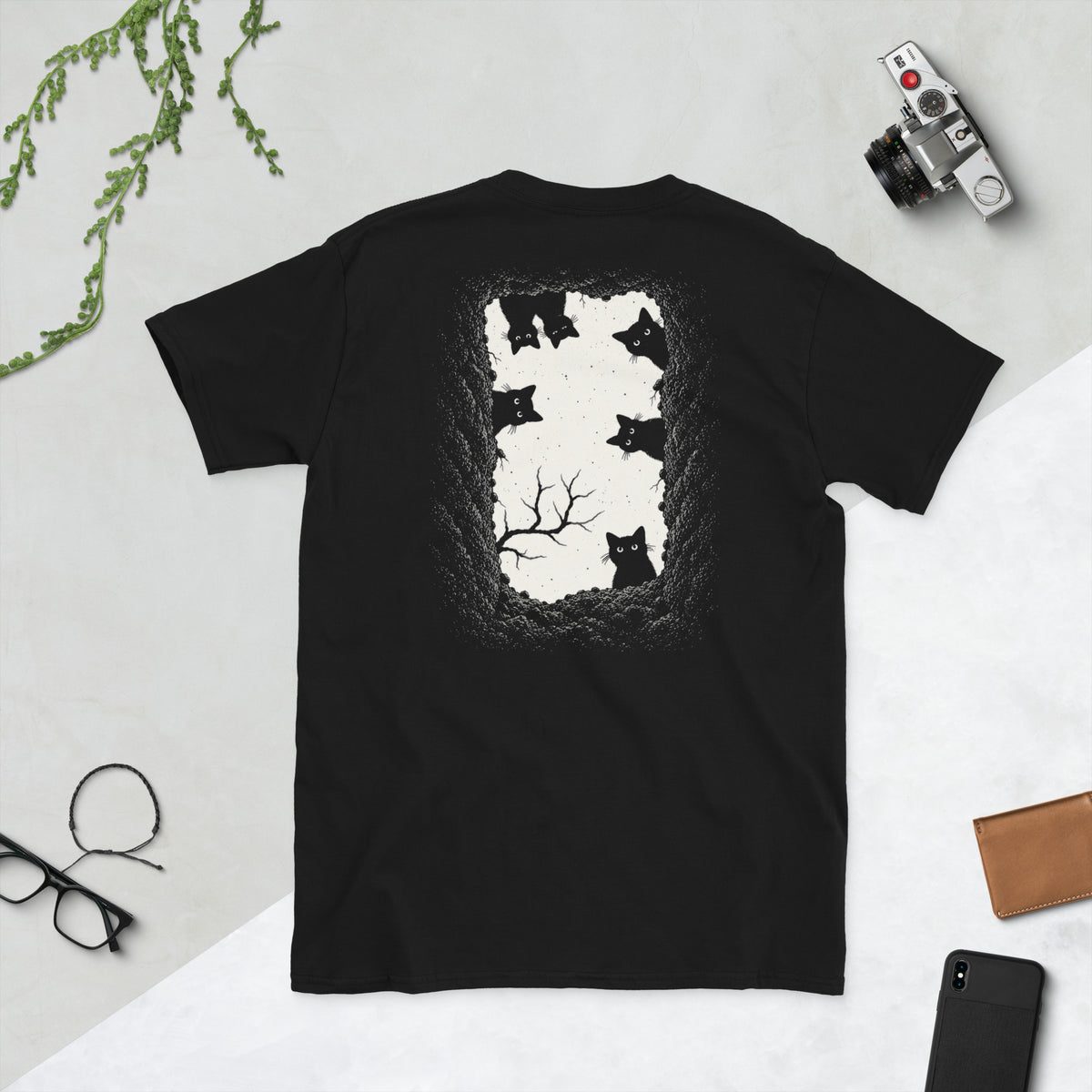 Back view of grave danger t-shirt, black graphic tee, gothic wordmark front design, black cat grave illustration back, two-sided halloween shirt, spooky cemetery graphic print, cream ink gothic lettering, torn earth night sky design, eerie cat peeking art, unisex crew neck shirt