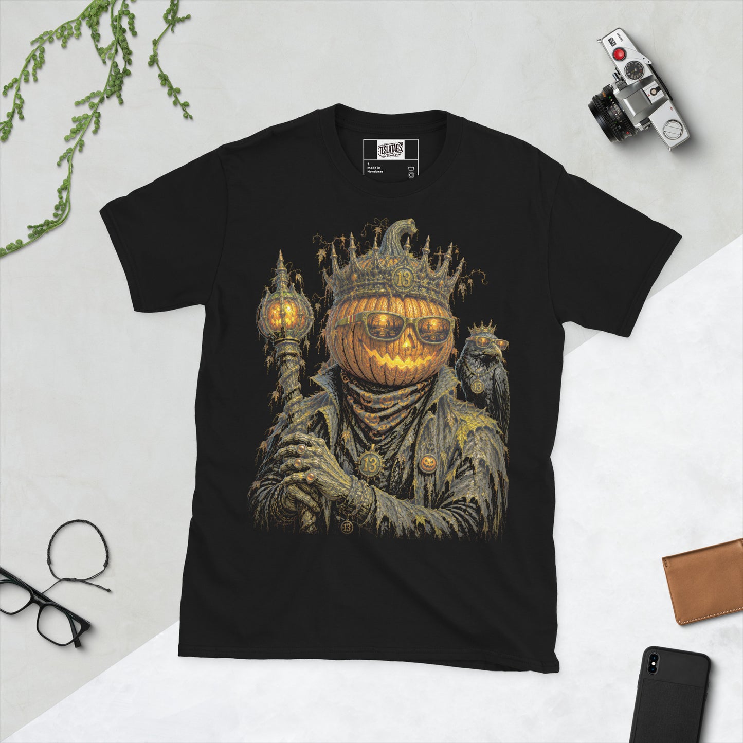 jack o lantern t-shirt, black graphic tee, crowned pumpkin king illustration, glowing carved pumpkin face, gothic sunglasses graveyard reflection, raven companion graphic, halloween king design, lantern scepter graphic, gothic streetwear tee, unisex crew neck shirt