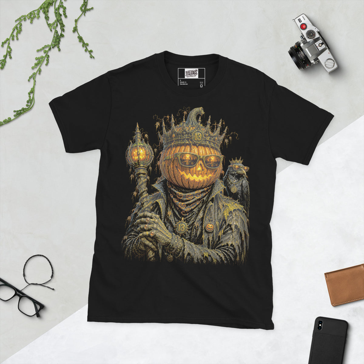 jack o lantern t-shirt, black graphic tee, crowned pumpkin king illustration, glowing carved pumpkin face, gothic sunglasses graveyard reflection, raven companion graphic, halloween king design, lantern scepter graphic, gothic streetwear tee, unisex crew neck shirt