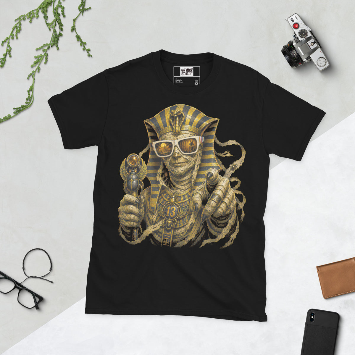 pharaoh mummy t-shirt, black graphic tee, egyptian king illustration, gold striped headdress design, bandaged pharaoh graphic, gothic sunglasses pyramid reflection, scarab scepter design, halloween mummy tee, ancient egyptian streetwear tee, unisex crew neck shirt