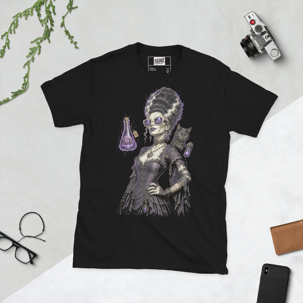 gothic bride t-shirt, black graphic tee, stitched bride illustration, electric white streaked updo, purple cat eye glasses design, glowing potion companion, black cat collar graphic, halloween horror tee, gothic streetwear design, unisex crew neck shirt