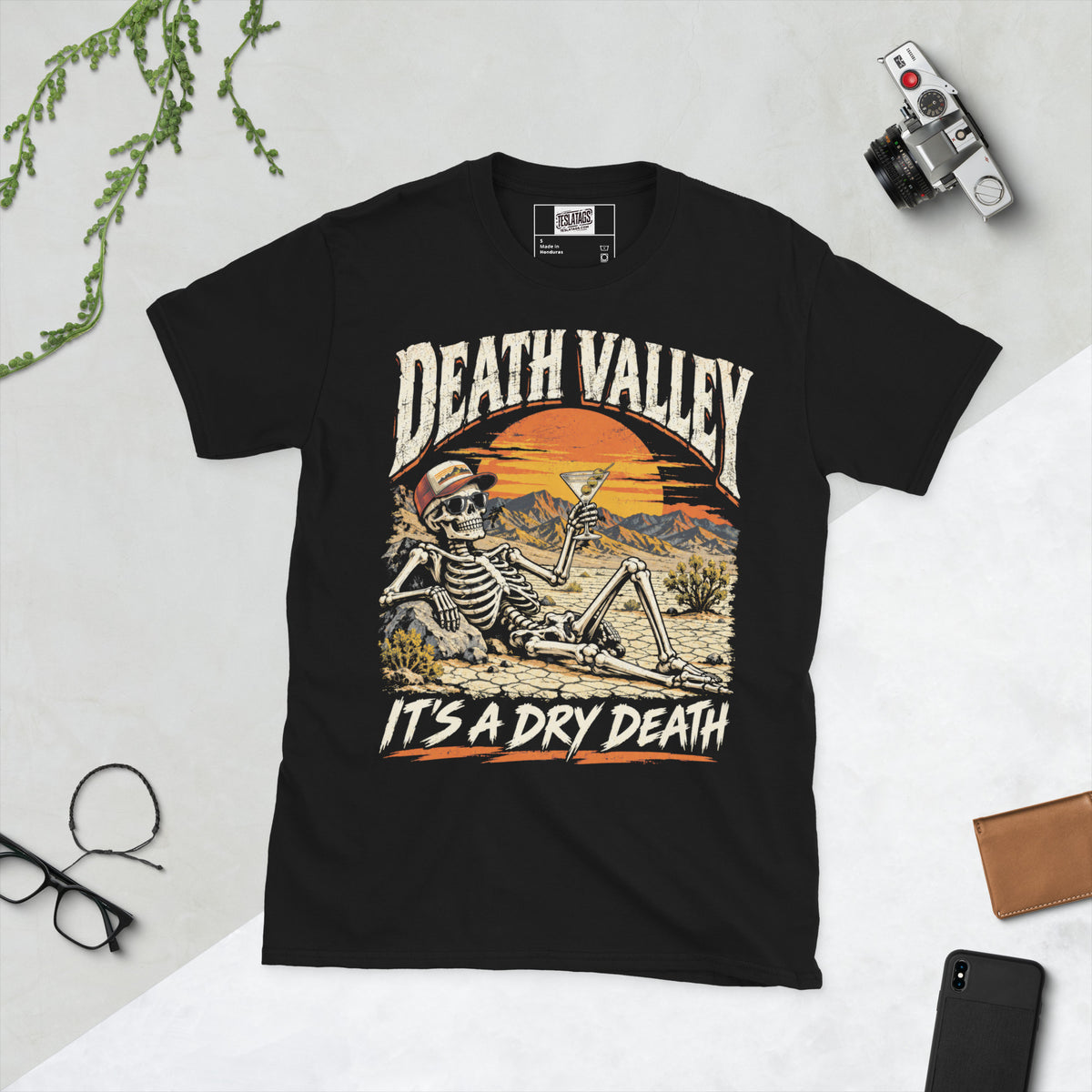 death valley skeleton t-shirt, black graphic tee, skull in sunglasses illustration, desert sunset badge design, martini cocktail graphic, vintage travel style print, cracked desert landscape art, dry humor streetwear shirt, unisex crew neck shirt
