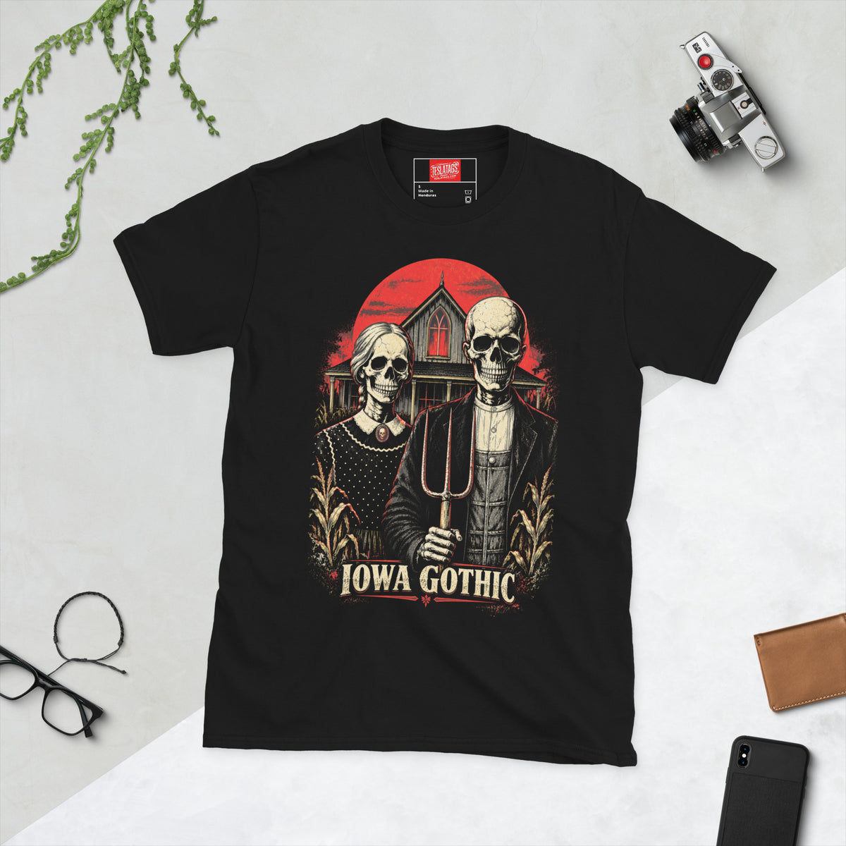 iowa gothic t-shirt, black graphic tee, skeleton farm couple illustration, gothic farmhouse graphic design, american gothic parody print, pitchfork skull art, blood red sky design, midwest horror streetwear shirt, cornfield gothic graphic, unisex crew neck shirt
