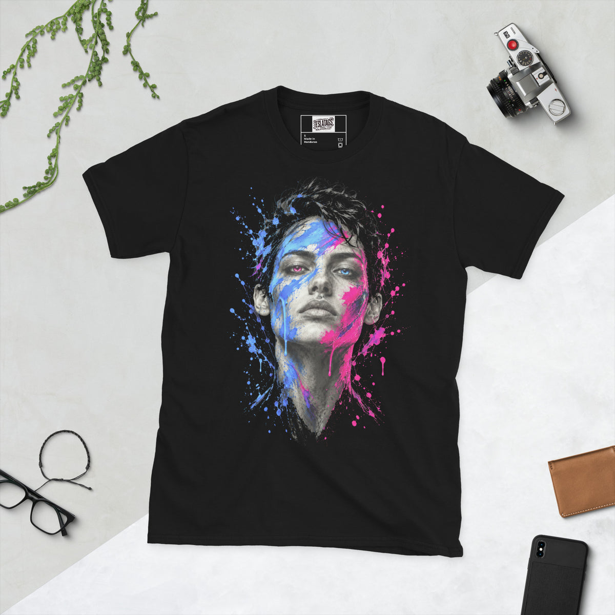 split decision t-shirt, black graphic tee, two-tone face illustration, blue and pink paint splatter design, dripping paint graphic print, electric blue and hot pink accents, dual color portrait art, bold streetwear graphic, high-detail photorealistic print, unisex crew neck shirt