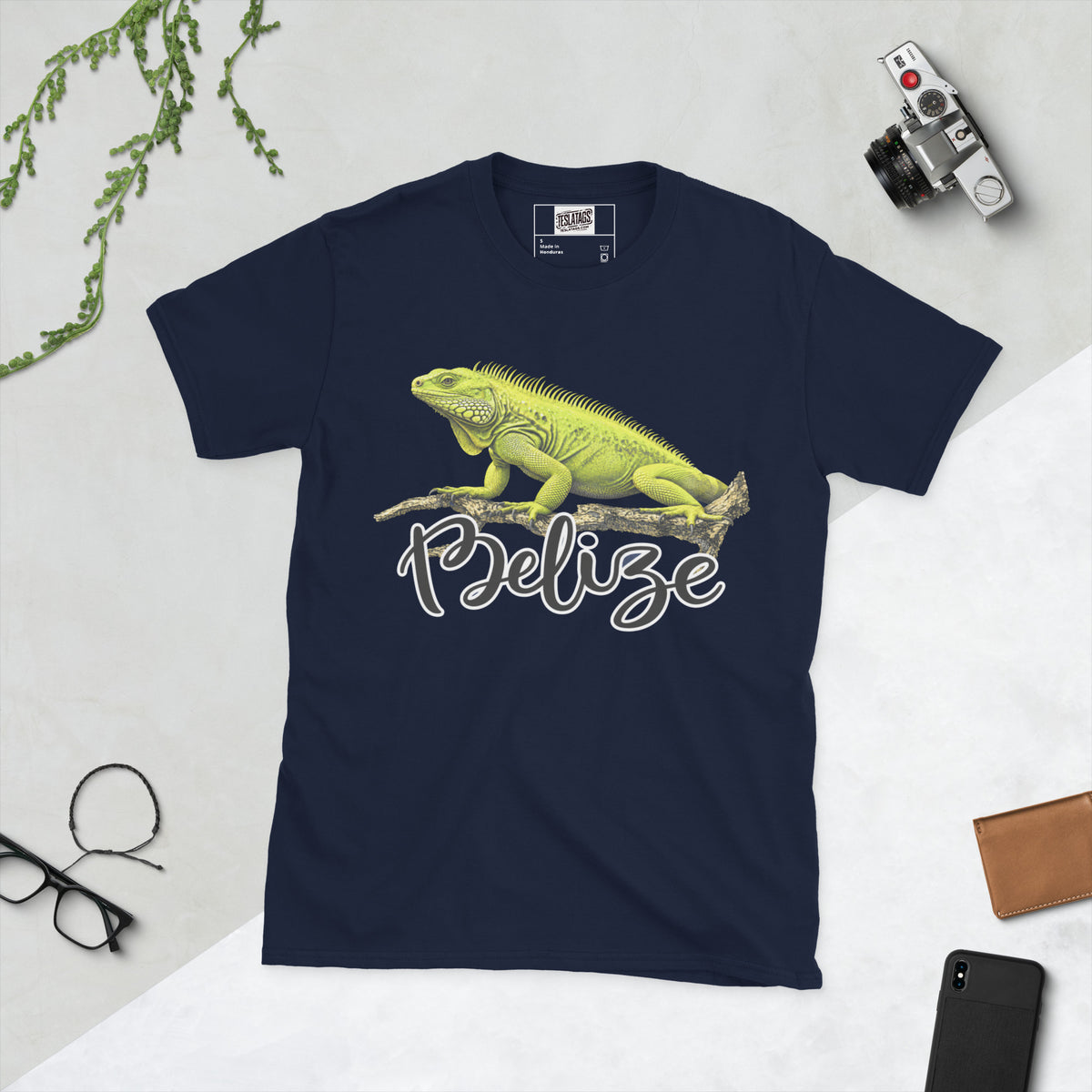 belize t-shirt, green iguana illustration, tropical wildlife graphic, iguana on branch design, hand-lettered script wordmark, reptile lover tee, travel destination shirt, vacation souvenir graphic, nature documentary style print, unisex crew neck shirt, navy