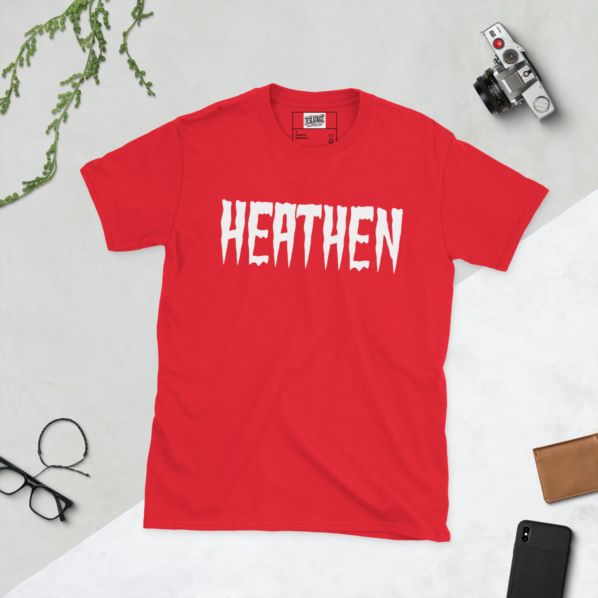 Heathen shirt red graphic tee, dripping horror-style white lettering design, red t-shirt product photo on plain background