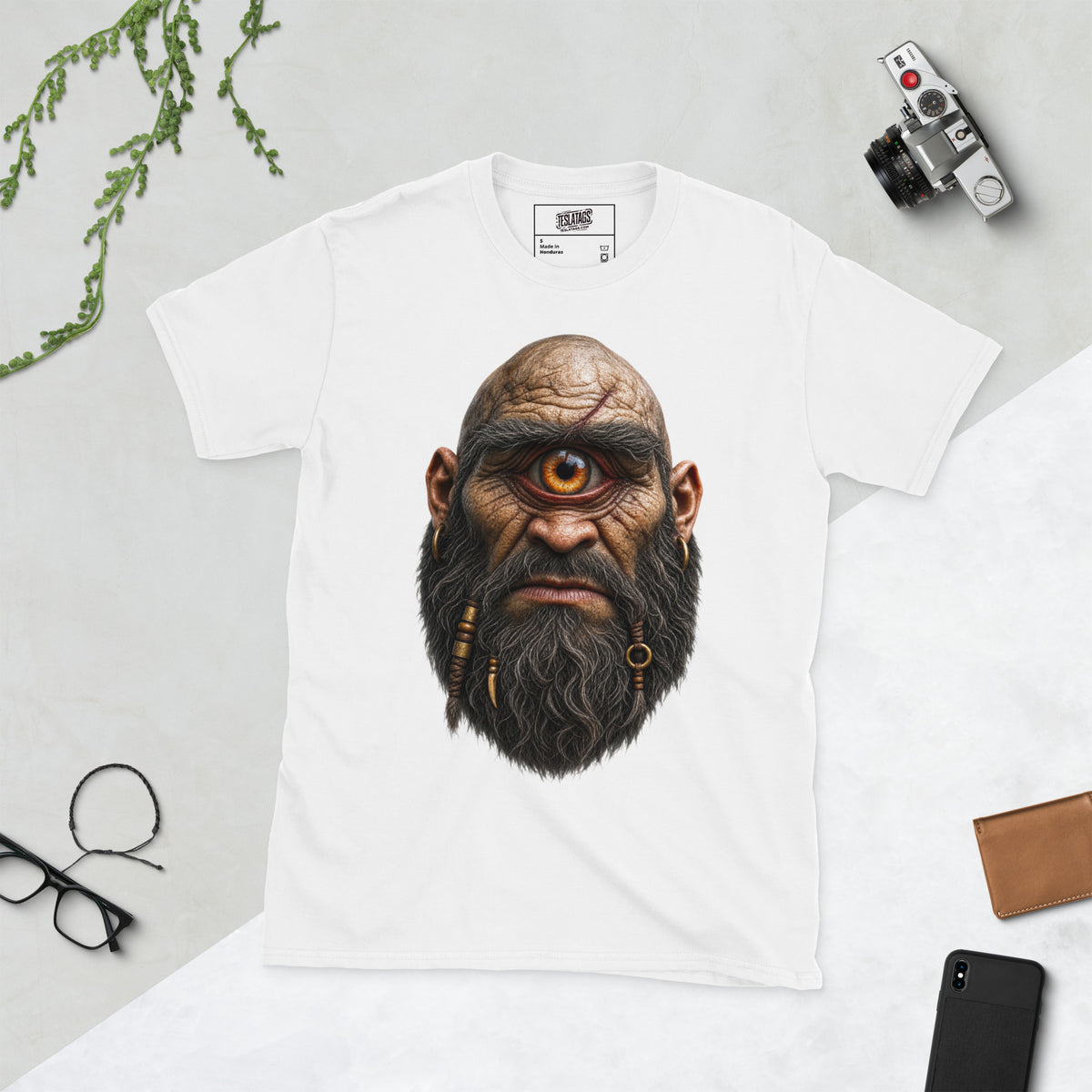 cyclops t-shirt, black and white graphic tee, one eyed giant illustration, braided beard design, gold hoop earring graphic, scarred bald head design, mythical monster tee, halloween horror shirt, gothic streetwear design, unisex crew neck shirt